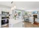 Bright kitchen with white cabinets, stainless steel appliances, and a center island with a white countertop at 7766 Jamestown S S Dr, Fishers, IN 46038
