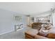 Spacious living room with a large sectional sofa and a view of the kitchen and front yard at 7766 Jamestown S S Dr, Fishers, IN 46038