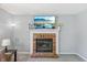 Living room with a brick fireplace and decorative mantle showcasing the TV at 7766 Jamestown S S Dr, Fishers, IN 46038