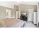 Neutral main bedroom with vaulted ceilings features a TV, dresser, and en-suite bathroom at 7766 Jamestown S S Dr, Fishers, IN 46038