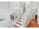 Staircase adjacent to dining room; half carpeted and half hardwood flooring at 7766 Jamestown S S Dr, Fishers, IN 46038