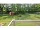 Spacious backyard enclosed by a chain-link fence with mature trees at 7879 Main St, Coatesville, IN 46121