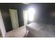 Small bedroom with black accent wall and light green walls, carpet, a bed and bright window at 7879 Main St, Coatesville, IN 46121