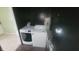 A look at a Laundry Room with black walls, a hot water tank and a washing machine and dryer at 7879 Main St, Coatesville, IN 46121