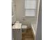 Bright white bathroom features a window for natural light, a toilet, sink and a bath tub at 802 N Oakland Ave, Indianapolis, IN 46201