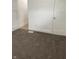 Neutral bedroom featuring plush carpet and white trim with a view into the hallway at 802 N Oakland Ave, Indianapolis, IN 46201