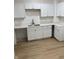 Kitchen with white cabinets, quartz countertops, and stainless steel sink at 802 N Oakland Ave, Indianapolis, IN 46201