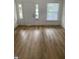 Living room featuring light wood floors, white walls, and natural light at 802 N Oakland Ave, Indianapolis, IN 46201