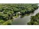 Aerial view of a lake house nestled among lush trees and serene waters at 8426 N Chickadee Dr, Morgantown, IN 46160