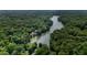 Stunning aerial view of a lake surrounded by lush greenery, showcasing waterfront homes at 8426 N Chickadee Dr, Morgantown, IN 46160