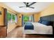 Cozy bedroom with a large window, ceiling fan and neutral color palette at 8426 N Chickadee Dr, Morgantown, IN 46160