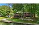 Charming lake house featuring decks, screened in porch, dock and stairs to the lake at 8426 N Chickadee Dr, Morgantown, IN 46160