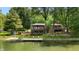 Beautiful lakeside home with a private dock and lush green surroundings at 8426 N Chickadee Dr, Morgantown, IN 46160