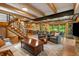 Open living room with wood beams, stairs, modern decor, and views of the kitchen at 8426 N Chickadee Dr, Morgantown, IN 46160