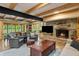 Cozy living room features a stone fireplace, wood beams, and waterfront views at 8426 N Chickadee Dr, Morgantown, IN 46160
