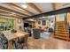 Bright living and dining area with wood floors and exposed beam ceiling at 8426 N Chickadee Dr, Morgantown, IN 46160