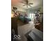 Bedroom featuring neutral walls, plush carpet, ceiling fan, and ample closet space at 8457 Kousa Dr, Indianapolis, IN 46234