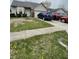 Ranch home featuring a tidy front yard, bay window, and attached two car garage at 8457 Kousa Dr, Indianapolis, IN 46234