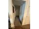 Narrow hallway featuring a brown carpet, neutral walls, and white doors at 8457 Kousa Dr, Indianapolis, IN 46234