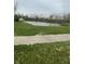 A serene pond bordered by lush green grass and mature trees, offering a peaceful view at 8457 Kousa Dr, Indianapolis, IN 46234