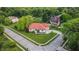 Aerial view of landscaped property with brick home and manicured lawn at 8703 Gordonshire Dr, Indianapolis, IN 46278