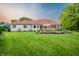 Lush backyard featuring a patio, seating area, and well-maintained lawn at 8703 Gordonshire Dr, Indianapolis, IN 46278