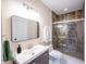 Bathroom with decorative tile shower and modern vanity at 8703 Gordonshire Dr, Indianapolis, IN 46278