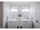 Bright bathroom with double vanities, mirrors, and modern lighting fixtures at 8703 Gordonshire Dr, Indianapolis, IN 46278