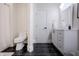 Modern bathroom with black marble floors, a toilet, a vanity and modern fixtures at 8703 Gordonshire Dr, Indianapolis, IN 46278