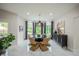 Bright dining room boasts modern furniture, a bay window overlooking lush greenery, and neutral color palette at 8703 Gordonshire Dr, Indianapolis, IN 46278