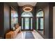 Elegant foyer with marble floors, designer lighting, and decorative mirror at 8703 Gordonshire Dr, Indianapolis, IN 46278