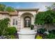 Elegant front entrance featuring arched doorway, brick accents, and landscaped garden at 8703 Gordonshire Dr, Indianapolis, IN 46278