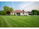 Charming single-story home with well-manicured lawn and brick exterior at 8703 Gordonshire Dr, Indianapolis, IN 46278
