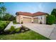 Spacious three-car garage and paved driveway, surrounded by green landscaping at 8703 Gordonshire Dr, Indianapolis, IN 46278