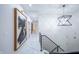 Bright hallway with modern lighting, railing, and contemporary artwork on display at 8703 Gordonshire Dr, Indianapolis, IN 46278