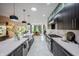 Gourmet kitchen featuring an island, stainless steel appliances, granite countertops, and dark wood cabinetry at 8703 Gordonshire Dr, Indianapolis, IN 46278