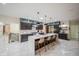 Spacious kitchen with a large island, pendant lighting, modern appliances, and dark wood cabinets at 8703 Gordonshire Dr, Indianapolis, IN 46278