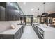 Modern kitchen featuring stainless steel appliances, waterfall countertops, and a large island at 8703 Gordonshire Dr, Indianapolis, IN 46278