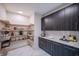 Well-organized pantry with modern shelving and storage, featuring ample counter space and dark wood cabinets at 8703 Gordonshire Dr, Indianapolis, IN 46278