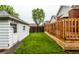 Backyard featuring a wooden deck, green lawn, and a white shed at 948 N Layman Ave, Indianapolis, IN 46219