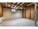 Unfinished basement with exposed beams and a small window at 948 N Layman Ave, Indianapolis, IN 46219
