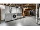 Basement laundry area with washer, dryer, and utility sink at 948 N Layman Ave, Indianapolis, IN 46219