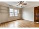 A clean and bright bedroom with hardwood floors, built in shelving and natural light at 948 N Layman Ave, Indianapolis, IN 46219