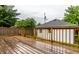 Wooden deck overlooking a lush backyard with trees and a shed at 948 N Layman Ave, Indianapolis, IN 46219