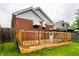 Wooden deck connected to a brick house with green lawn at 948 N Layman Ave, Indianapolis, IN 46219
