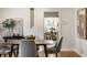 Elegant dining room with hardwood floors, neutral decor, and a view into an adjacent dining space at 948 N Layman Ave, Indianapolis, IN 46219