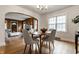 Charming dining room with hardwood floors, contemporary chairs, and an open view to the living area at 948 N Layman Ave, Indianapolis, IN 46219