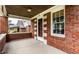 Inviting brick porch, showcasing a classic design with a window and an exterior door at 948 N Layman Ave, Indianapolis, IN 46219