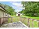 Backyard view showcasing a shed and green lawn from the vantage point of a wooden deck at 9608 Sycamore Rd, Carmel, IN 46032
