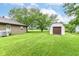Green backyard featuring a shed and lush lawn, presenting a serene outdoor space at 9608 Sycamore Rd, Carmel, IN 46032